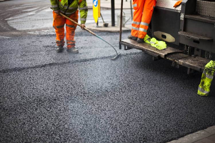 paving contract laying down asphalt